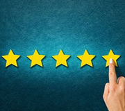 A hand points to the fifth yellow star in a row of five, symbolizing a top rating against a textured blue background.