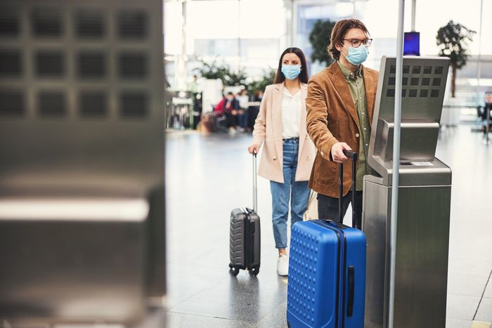 Man And Woman Holding Luggage Bag | Lawndale, CA | Flynn's Scale Service