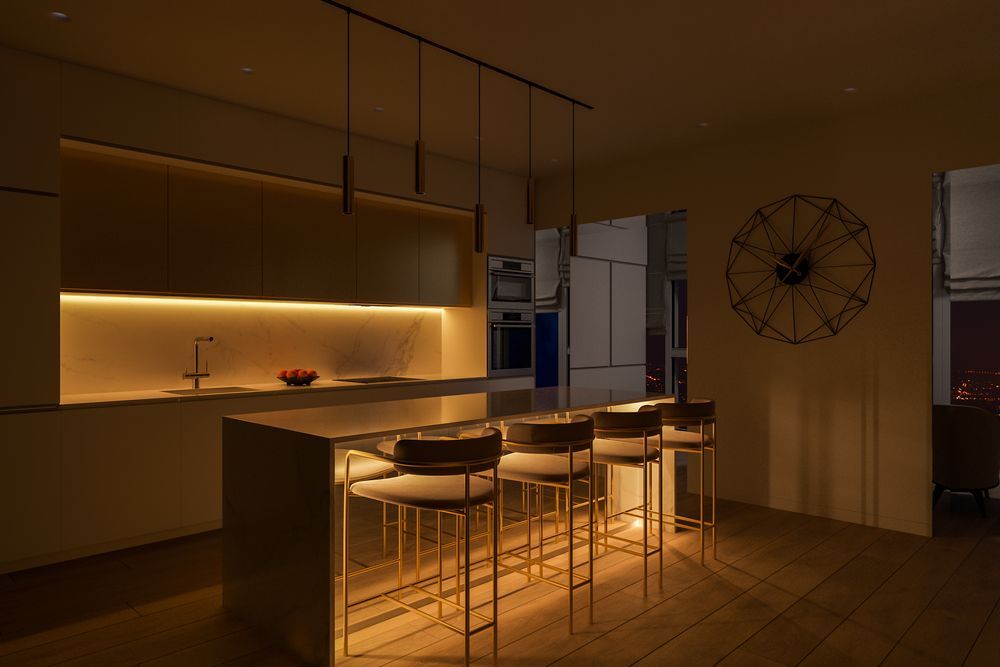 Modern kitchen with warm lighting, island with stools, and decorative clock on the wall — EBS NQ Electronic Building Systems in Kirwan, QLD