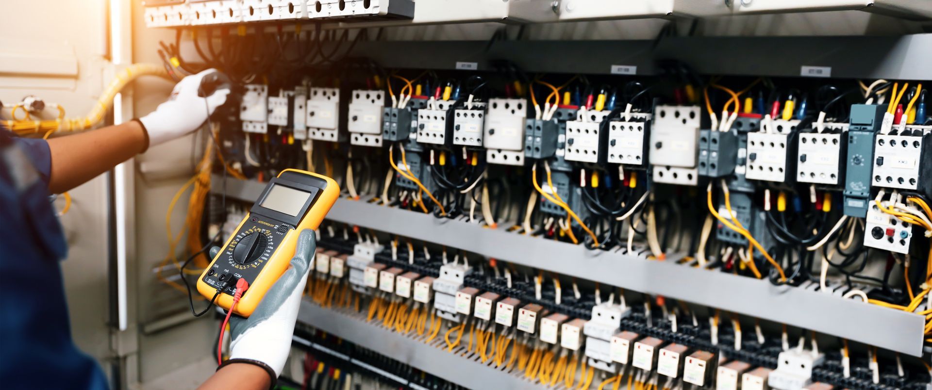 Electrician Using a Multimeter to Inspect Electrical — EBS NQ Electronic Building Systems in Kirwan, QLD