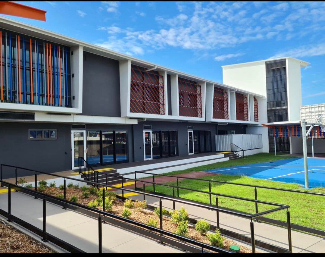School Building Exterior With Gray Walls, Red Trim — EBS NQ Electronic Building Systems in Kirwan, QLD