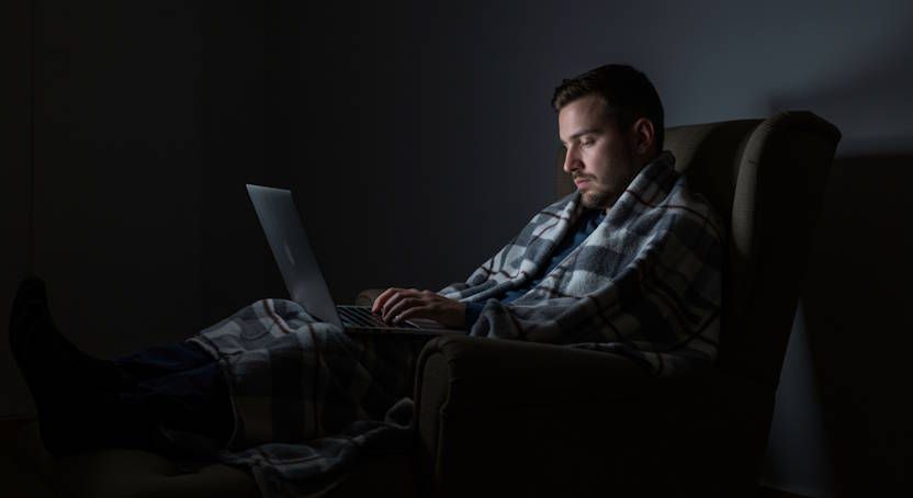 Dayton man reclined in armchair wrapped in blanket looking for answers to some of his questions about hypnosis and problems sleeping