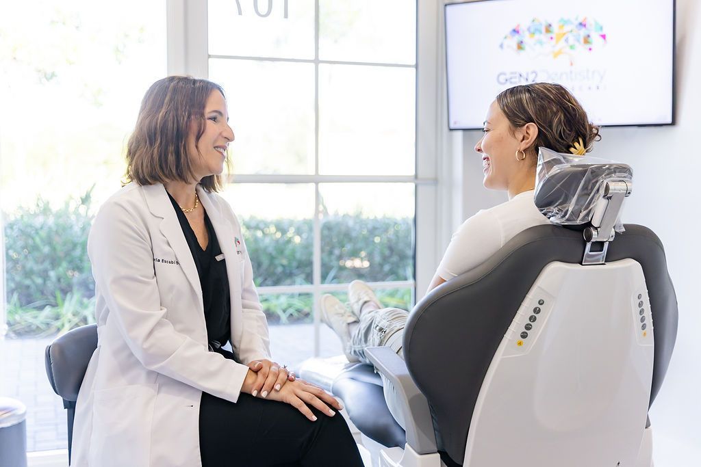 Dr. María Escabí talking with a patient during a consultation at GEN2 Dentistry in Davie, FL