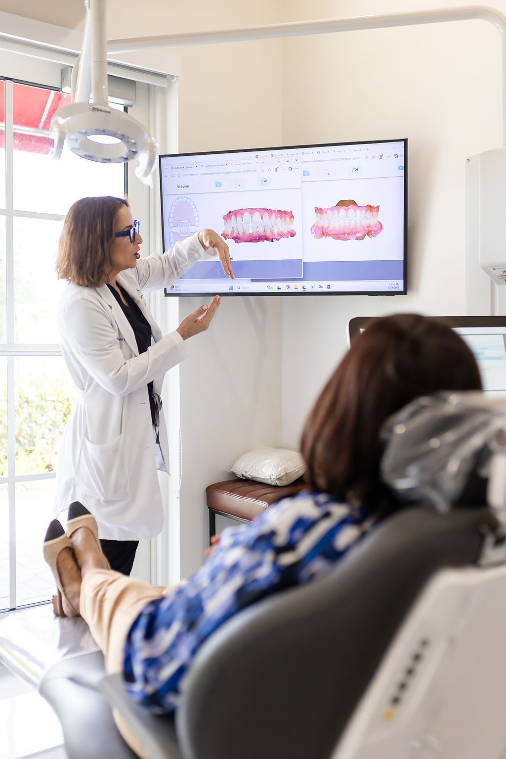 Dentist explaining dental X-rays to a patient in a clinic