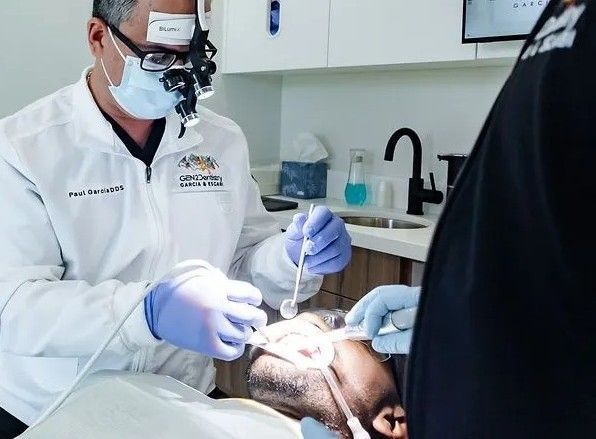 Dentist performing a dental procedure with advanced technology in a modern dental office.