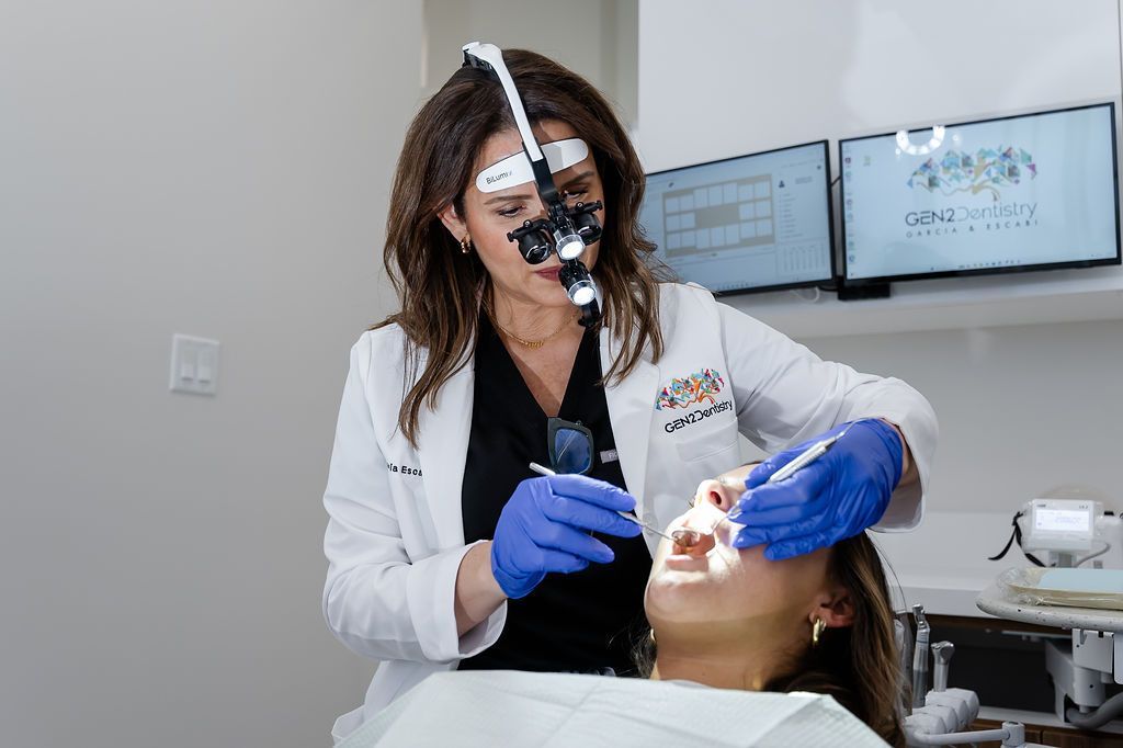 Dentist in white coat and blue gloves treating a patient