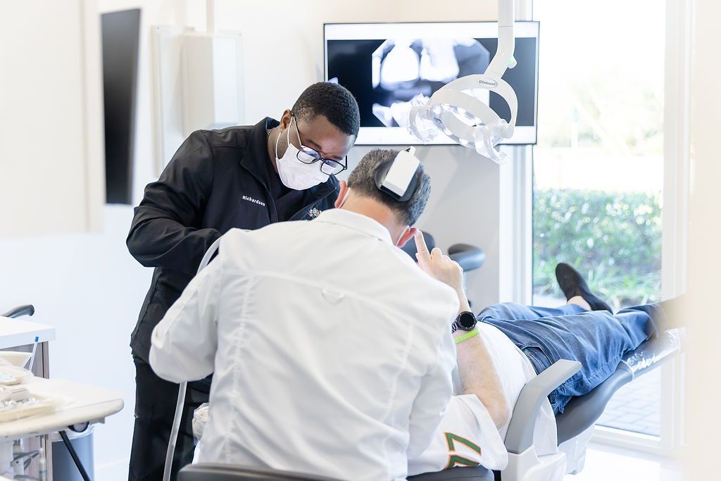 Dentist and assistant working chairside on a patient at GEN2 Dentistry