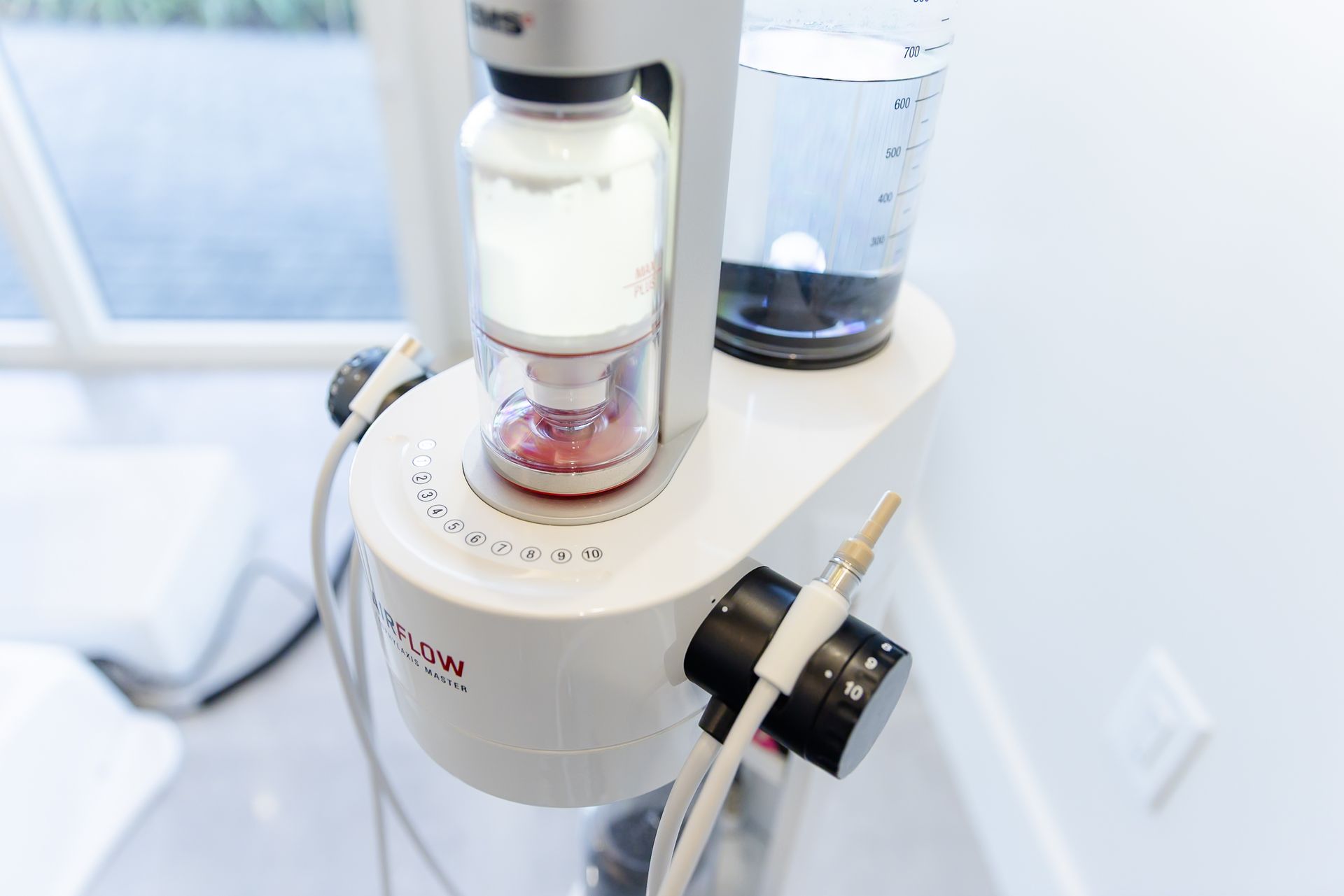 Guided Biofilm Therapy cleaning unit with warm water and powder chambers at GEN2 Dentistry in Davie, FL