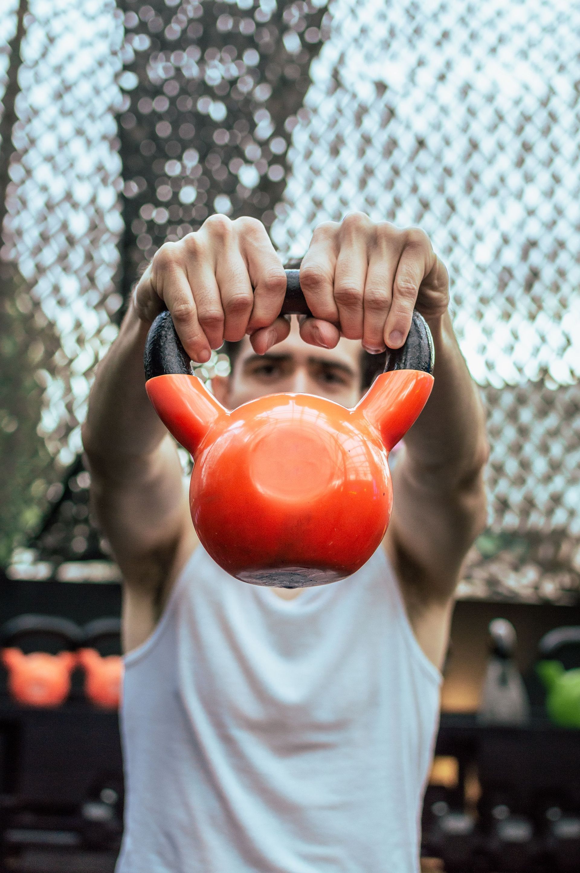 Illustrative stock photo of hands holding a kettlebell during adult strength training