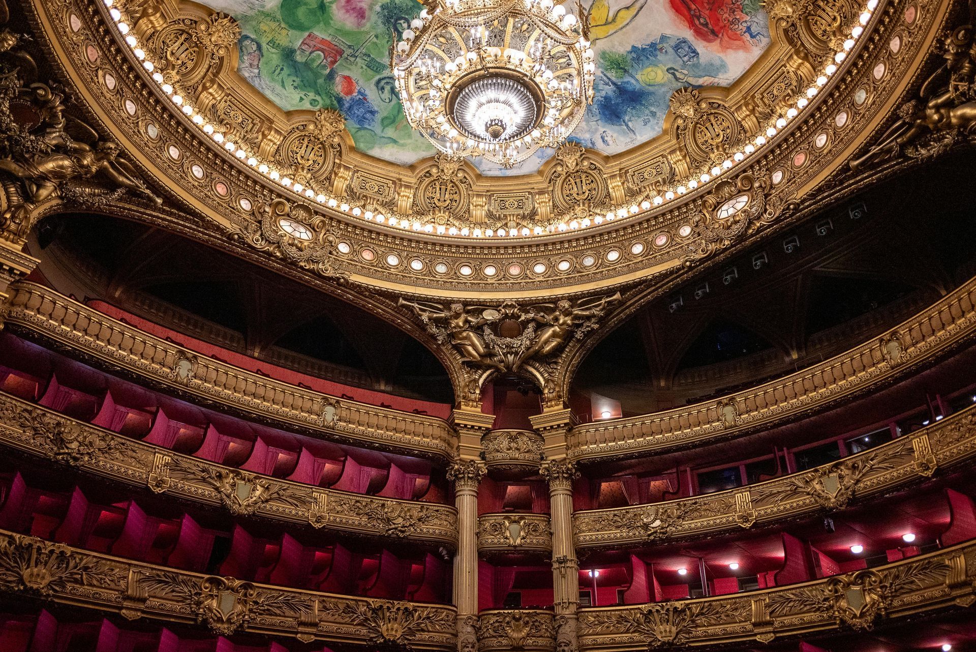 Richly decorated opera house interior, with tiered balconies and a gilded ceiling.