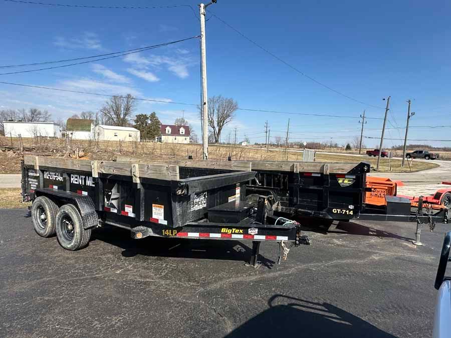 Two black dump trailers with 