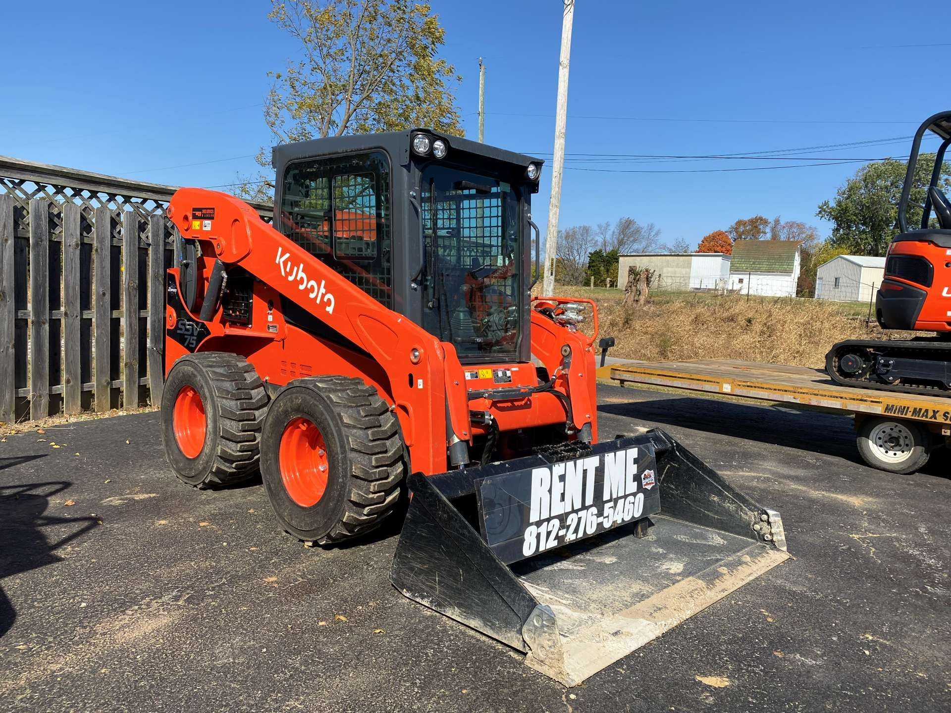 Orange Kubota skid steer loader with a 