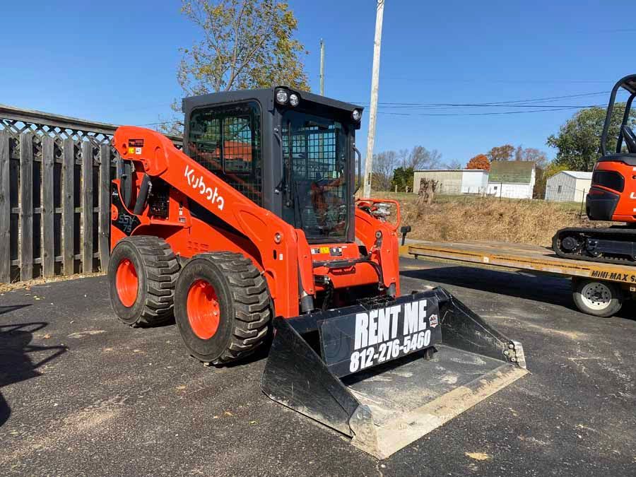 An orange Kubota skid steer loader with a 