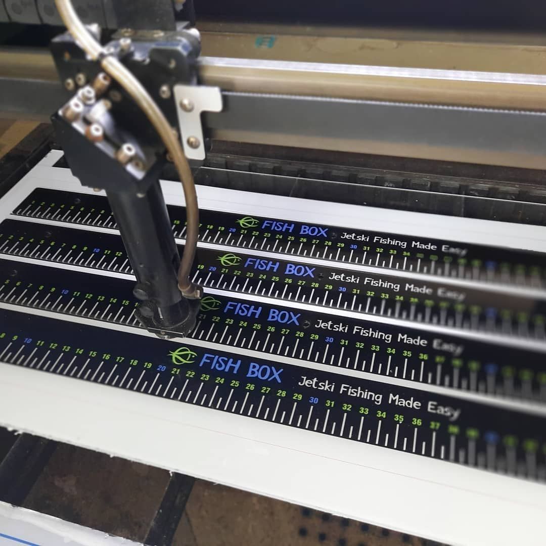A Machine is Cutting a Ruler That Says Fish Box — Coastal Plastics In Tweed Heads South, NSW