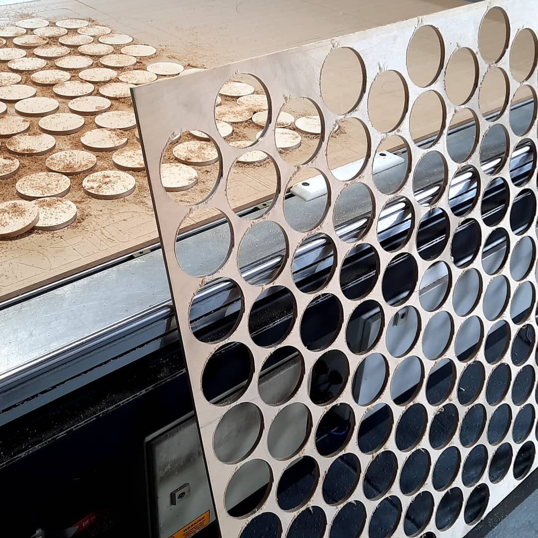 A Piece of Wood With Holes in It is Sitting on Top of a Table — Coastal Plastics In Tweed Heads South, NSW
