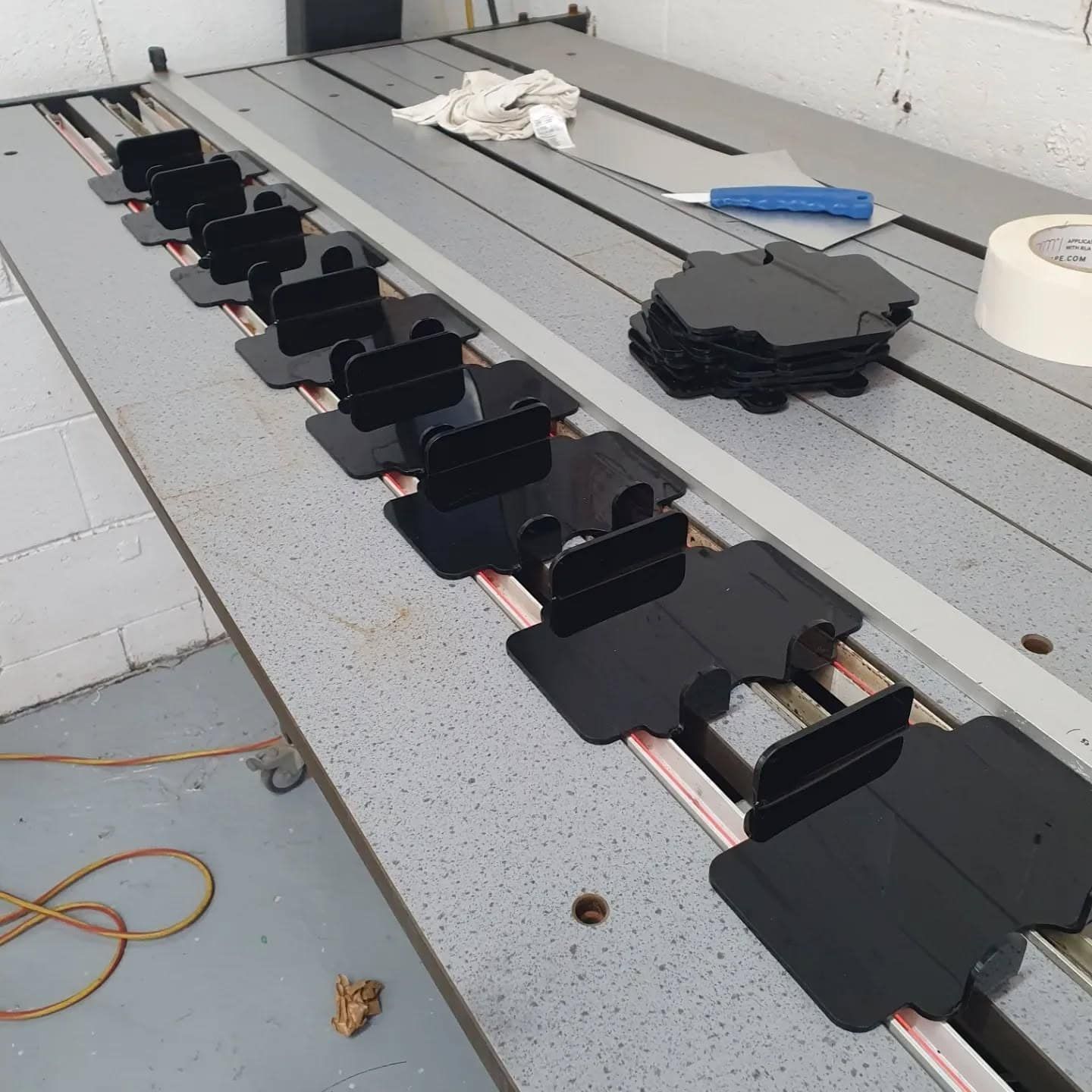 A Table With a Bunch of Black Objects on It — Coastal Plastics In Tweed Heads South, NSW