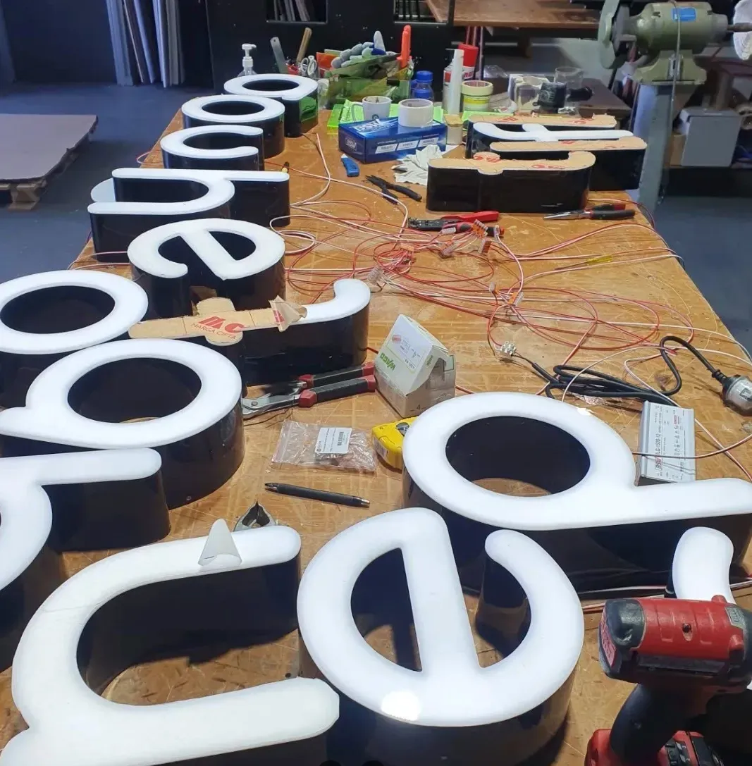 Plastic Fabricated Signage Lettering on a Table — Coastal Plastics In Armidale, NSW