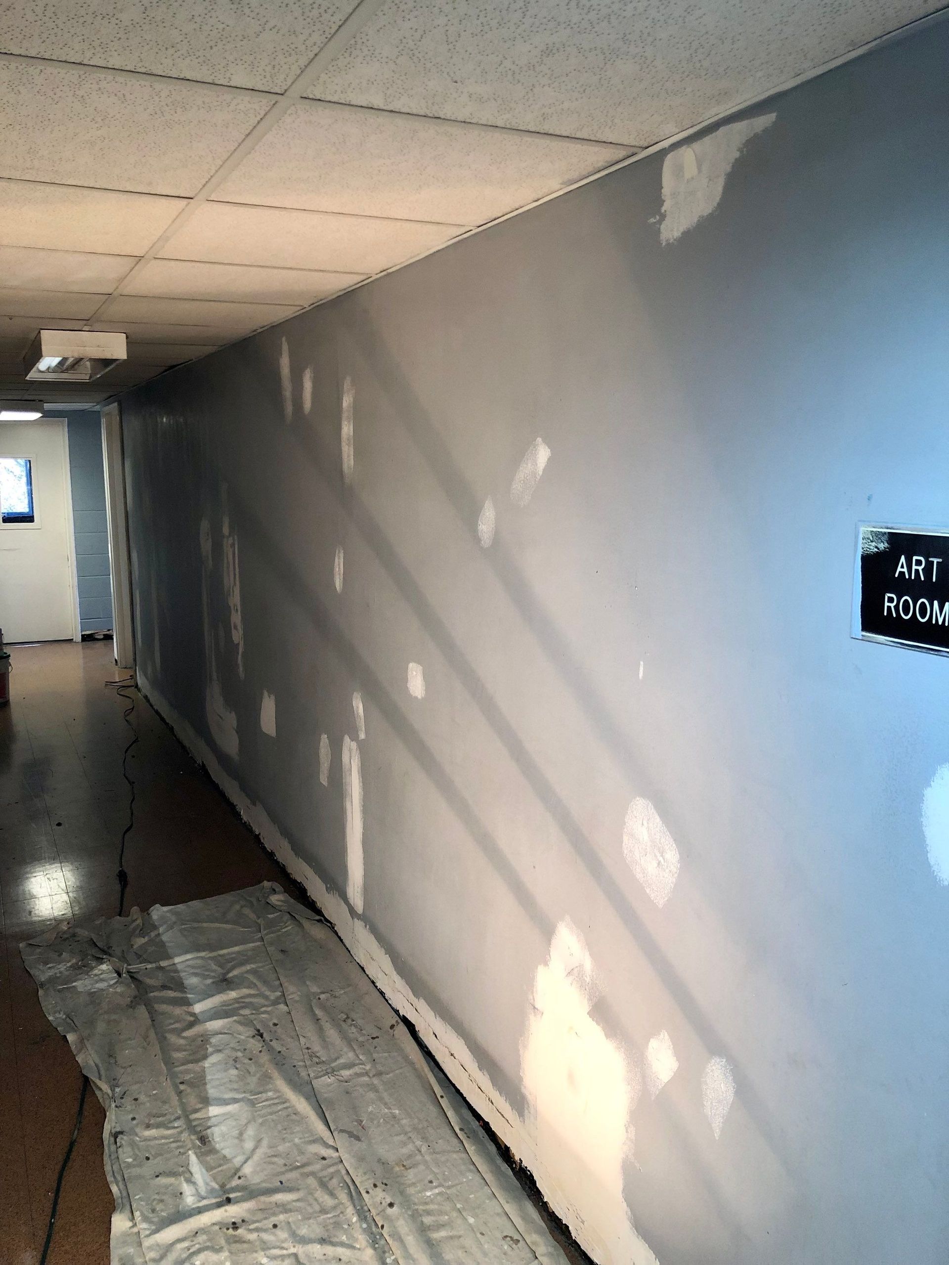 A hallway with a sign on the wall that says ' a ' on it