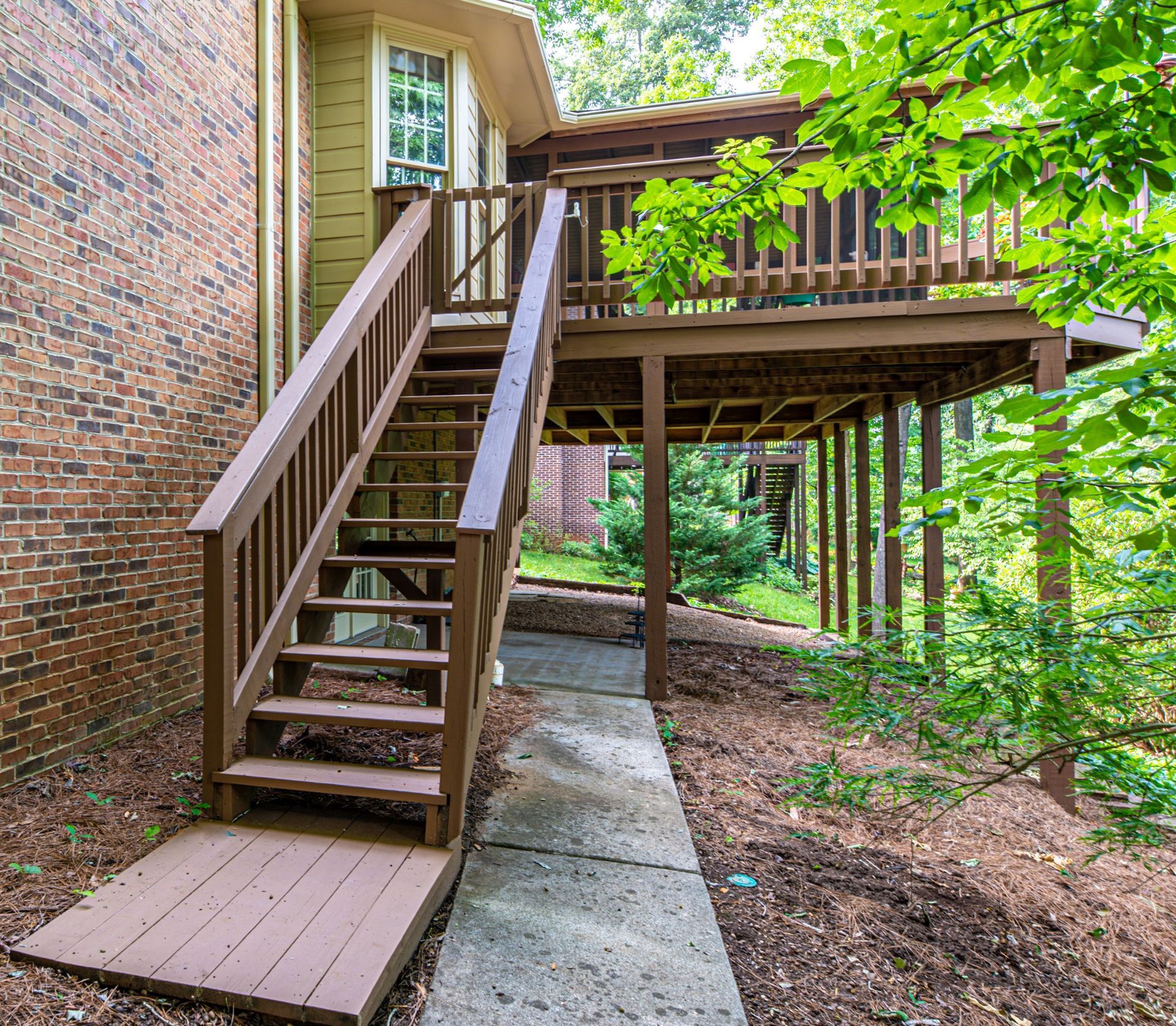 A wooden deck with stairs leading up to it