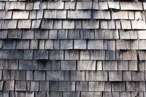 A close up of a wooden roof with shingles.