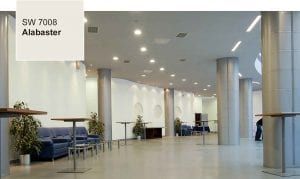 A large room with tables and chairs and a sign that says sw 7008 alabaster