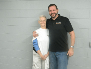 A man in a black shirt stands next to a woman in a white shirt