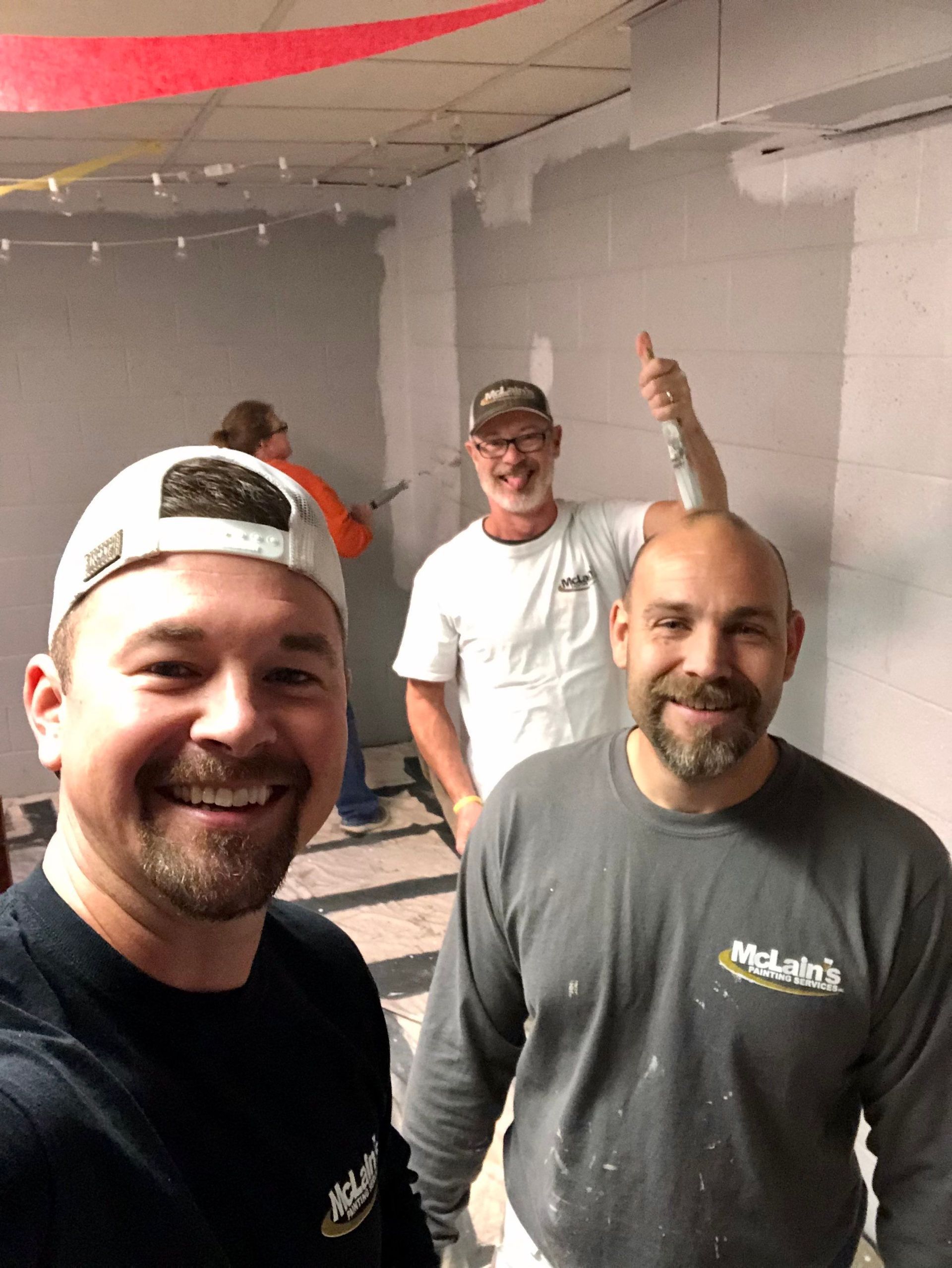 A group of men are standing next to each other in a room.