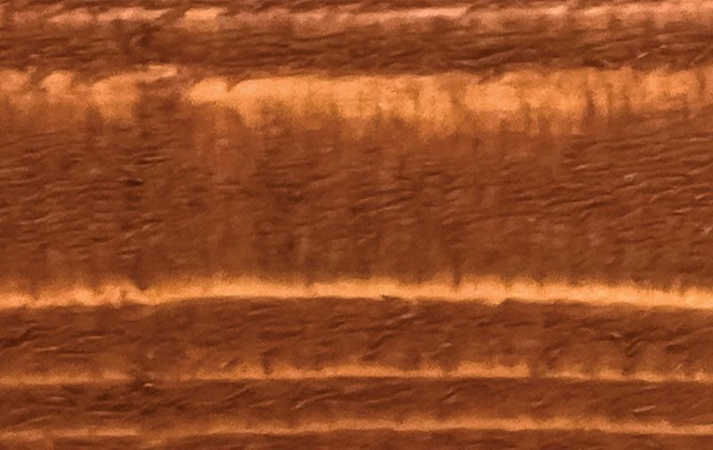 A close up of a piece of wood showing the grain and texture.