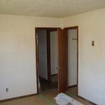A room with white walls and a door that is open.