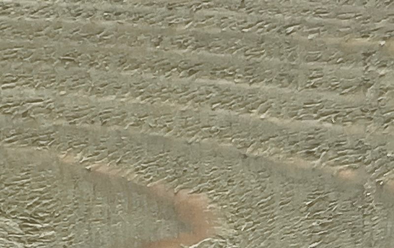 A close up of a piece of wood with a grainy texture.