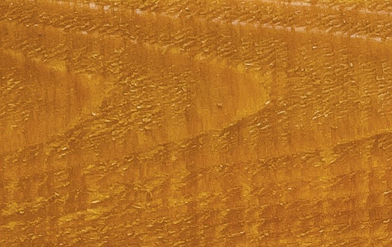 A close up of a piece of wood showing the texture of the wood.