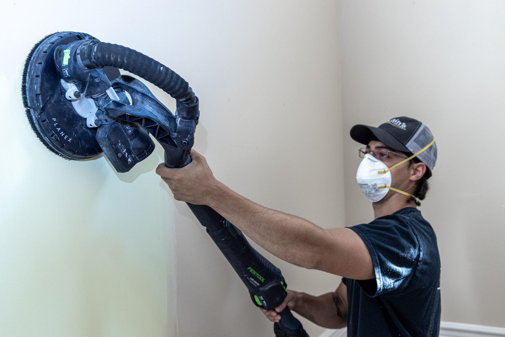 McLains Painting employee prepping wall before paint