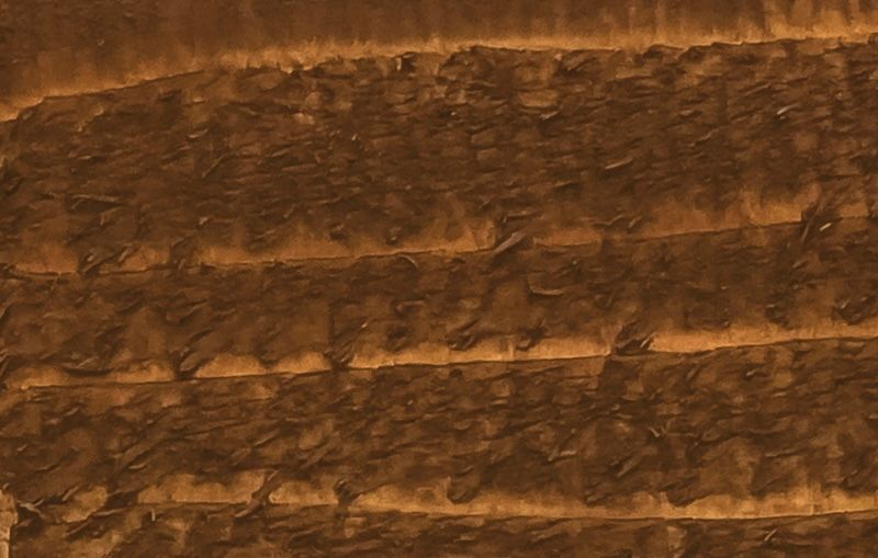 A close up of a piece of brown wood.