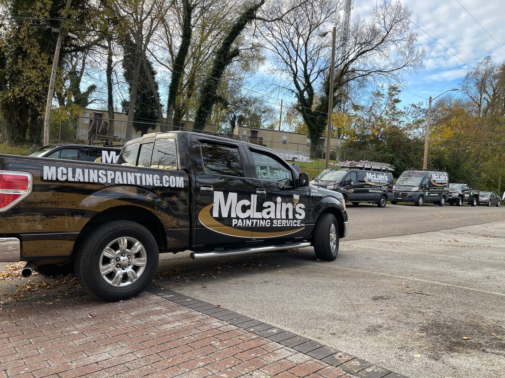A black truck is parked in a parking lot.