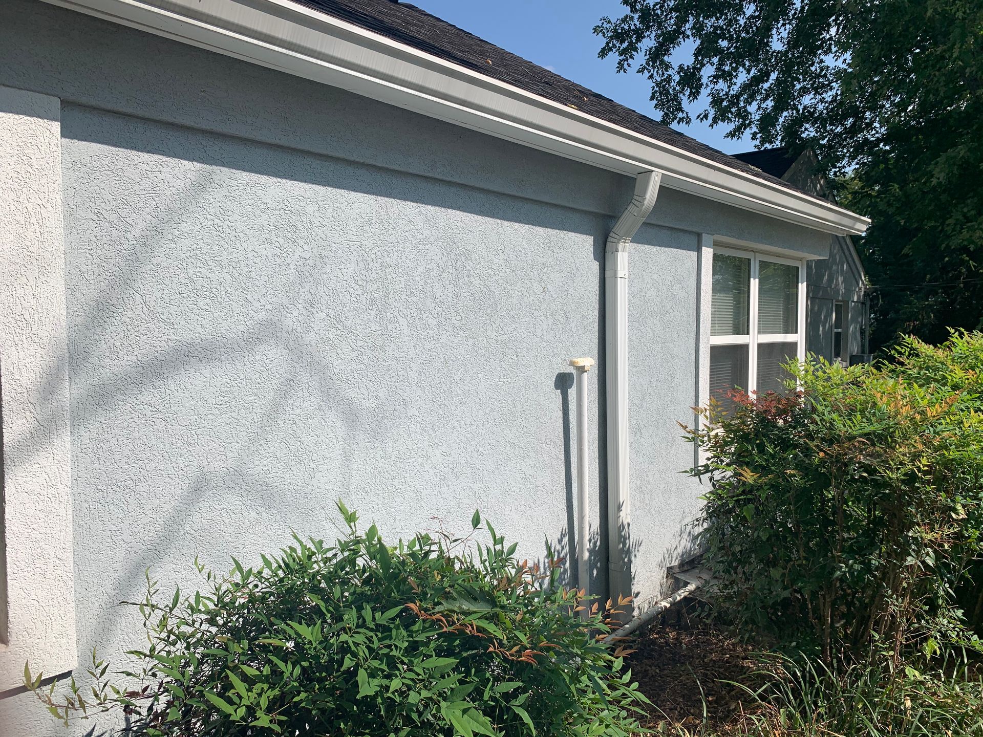 A house with a gutter on the side of it