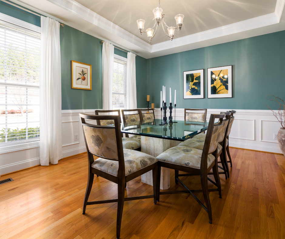 a dining room with a glass table and chairs