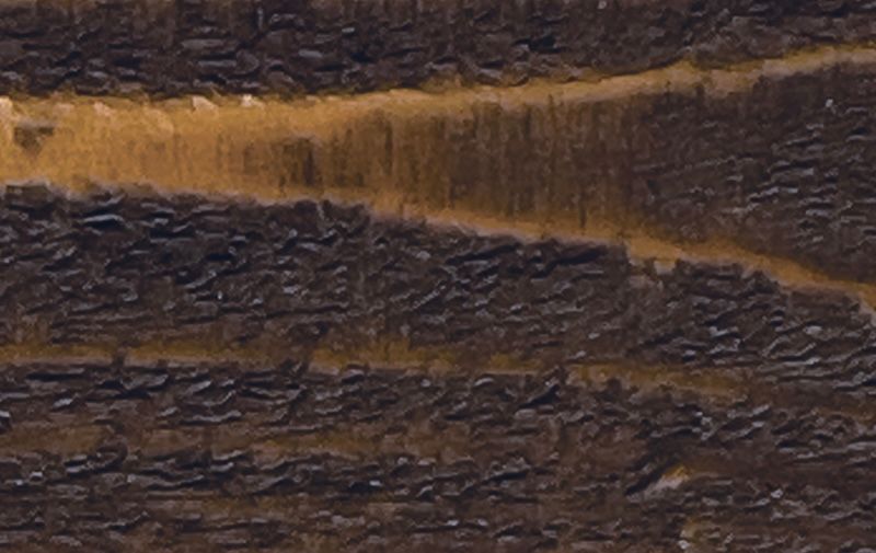 A close up of a piece of wood showing the texture of the wood.