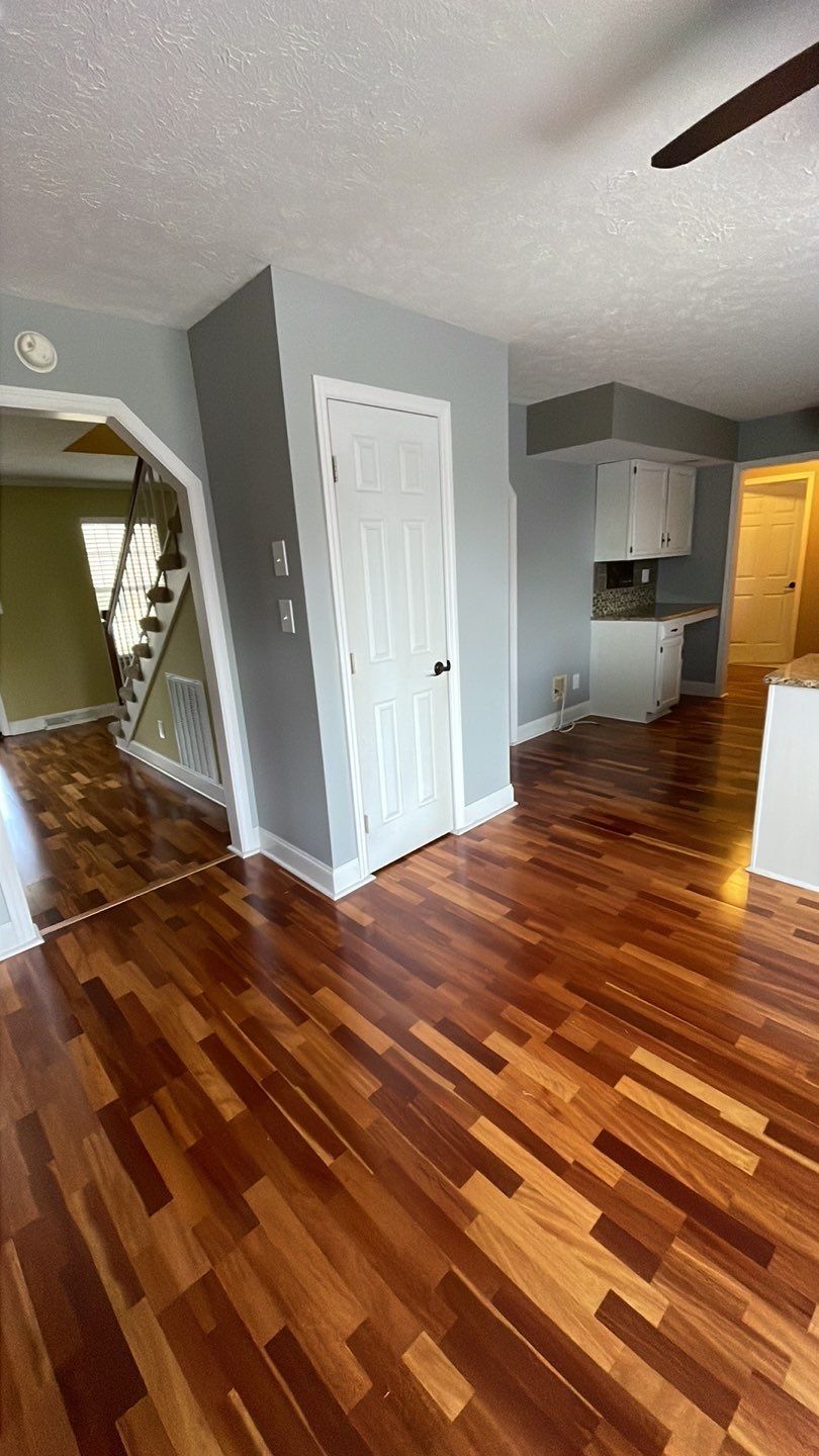 a living room with hardwood floors and a ceiling fan .