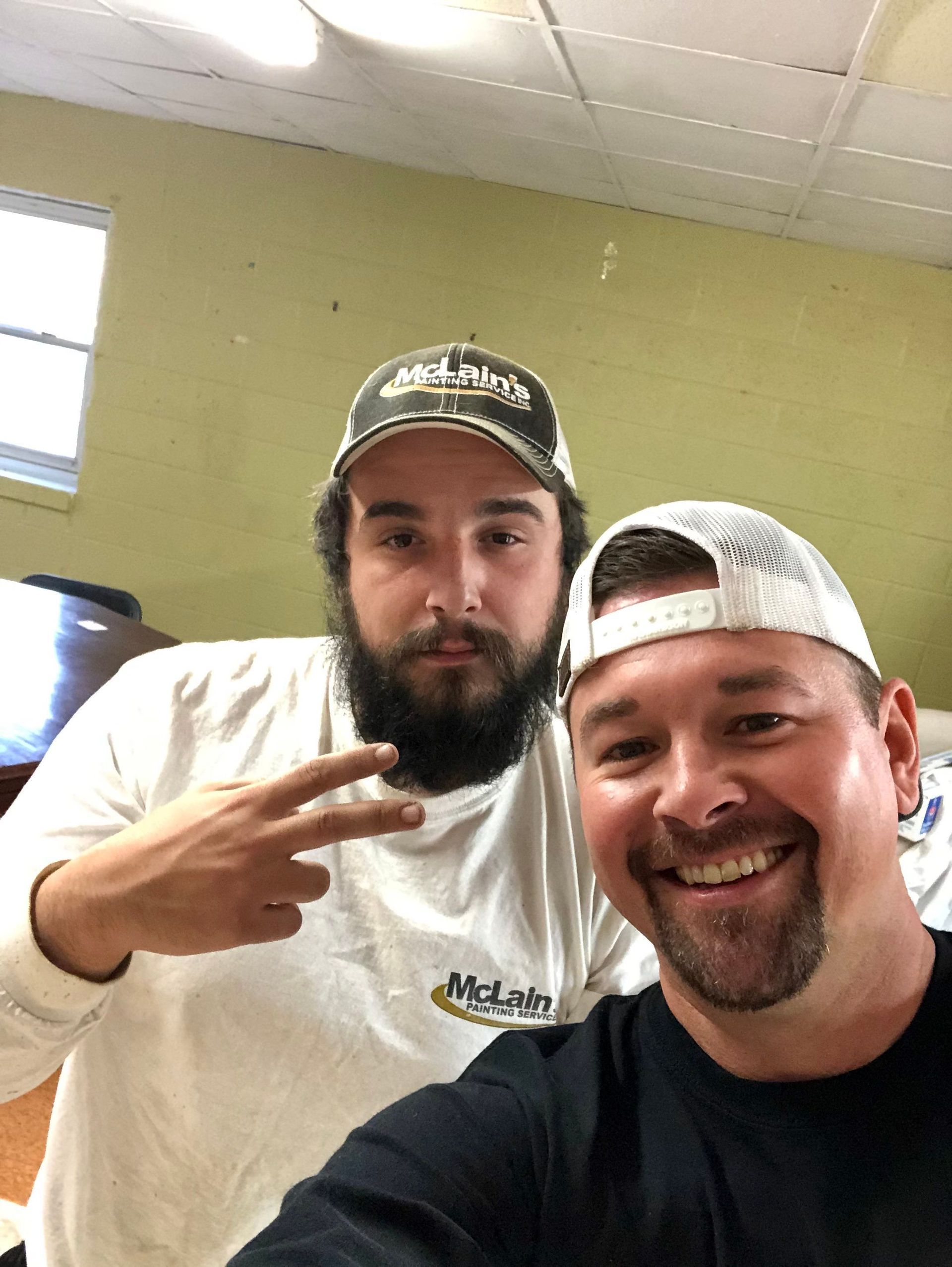 Two men are posing for a picture and one has a beard