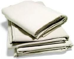 A pile of white sheets stacked on top of each other on a white surface.