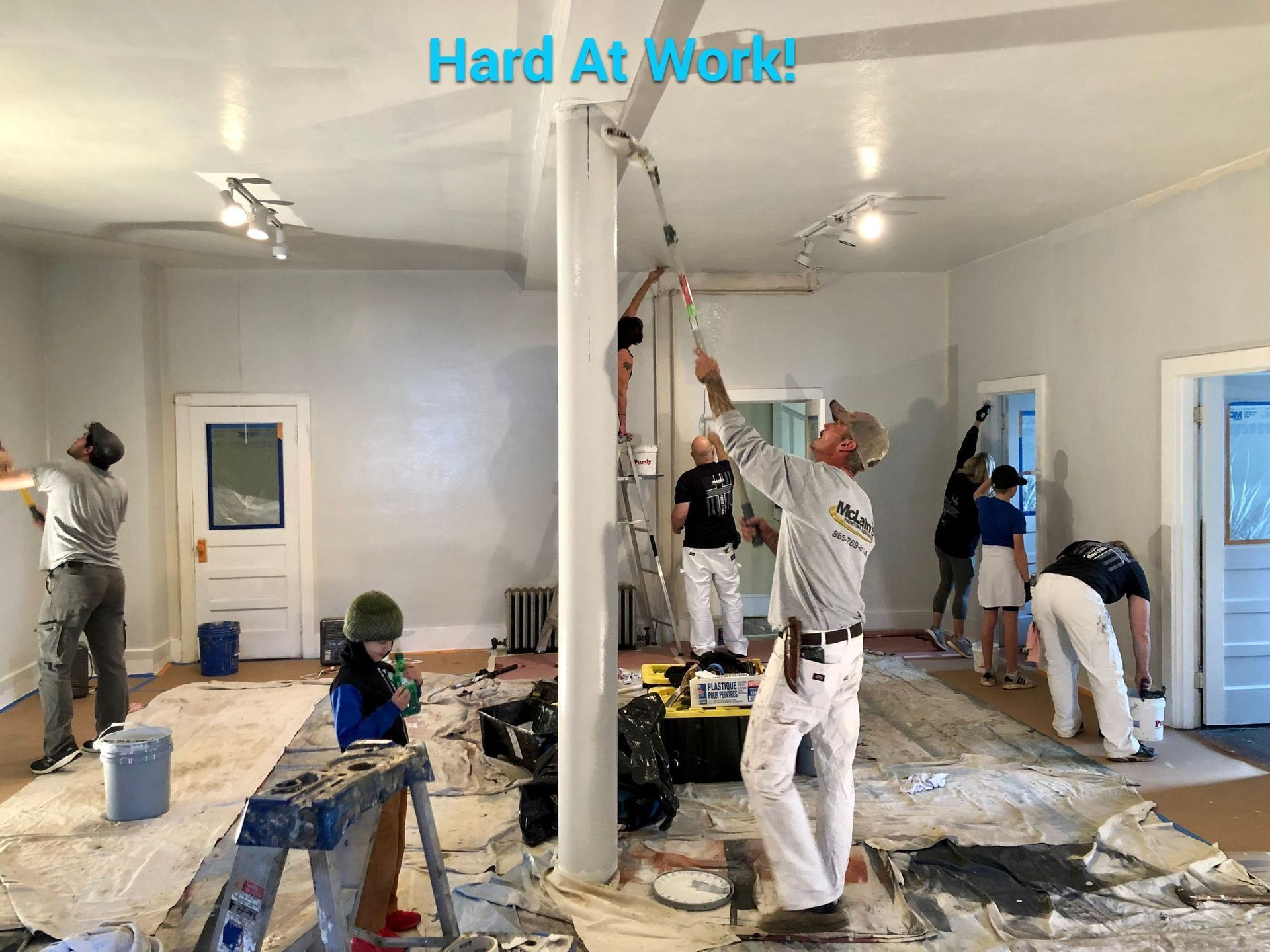 A group of people are painting a room together.