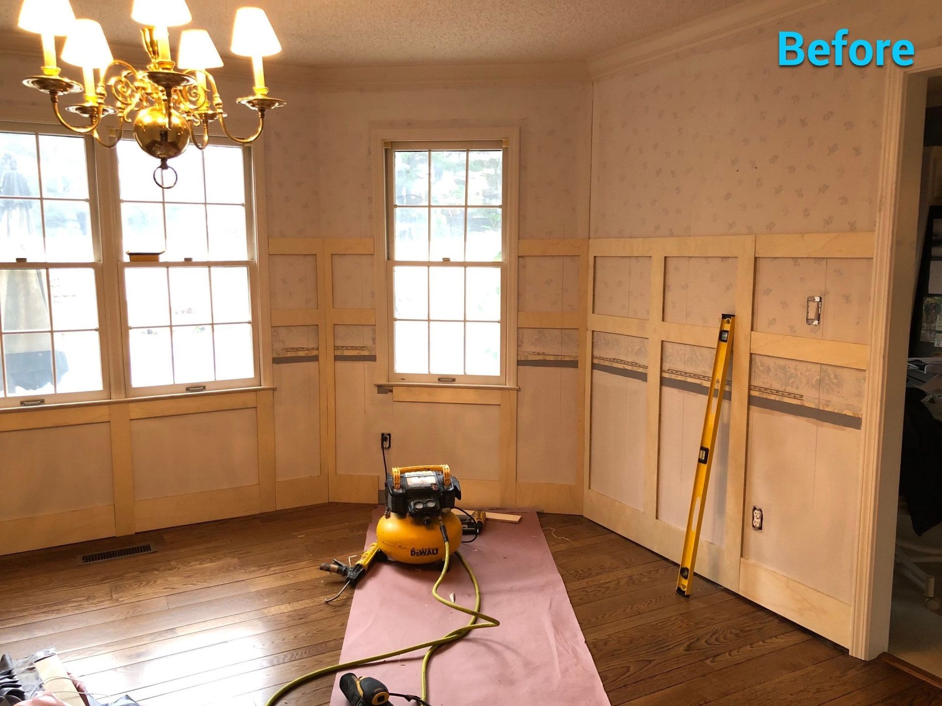 A before picture of a room with a chandelier