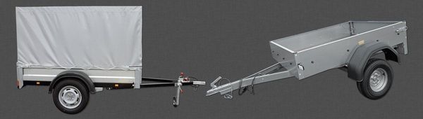 Two gray utility trailers on a dark background. One has a white cover.