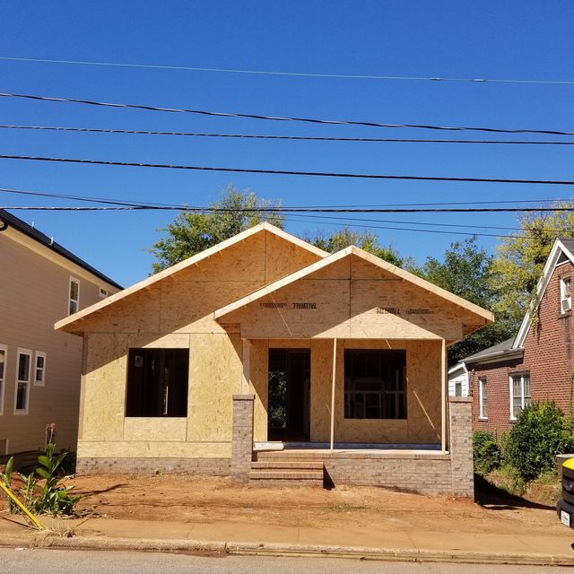A house that is being built with a blue sky in the background