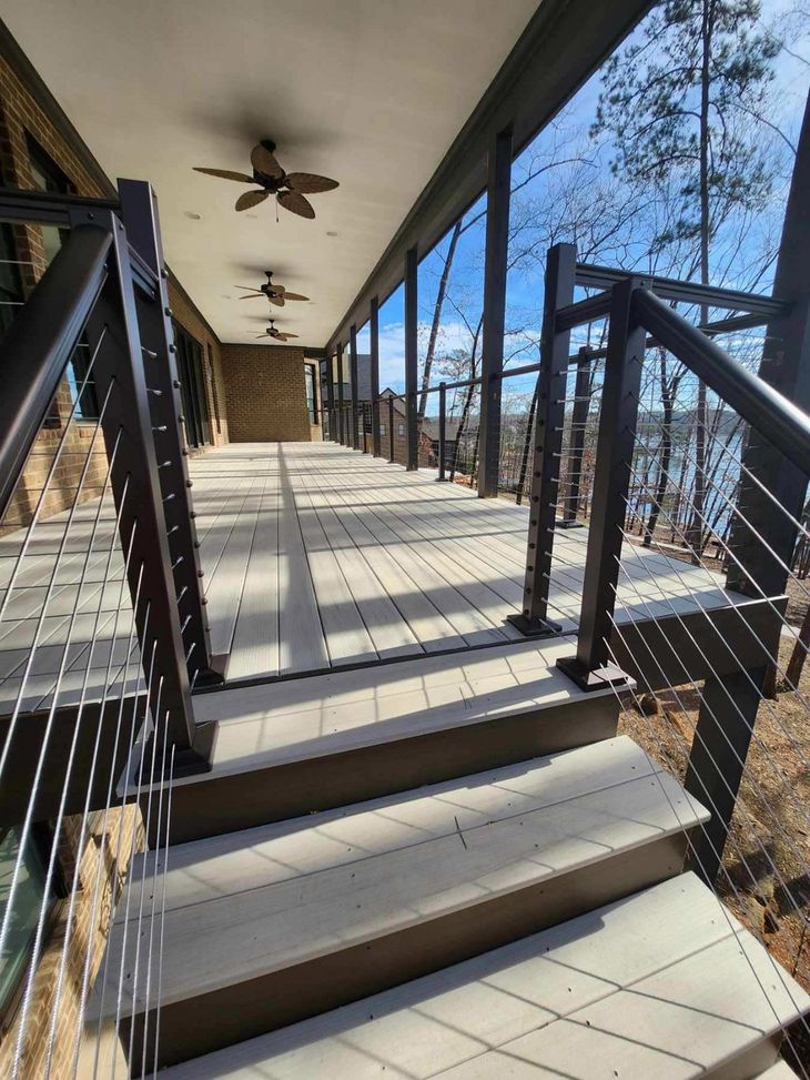 A staircase leading up to a porch with a ceiling fan.