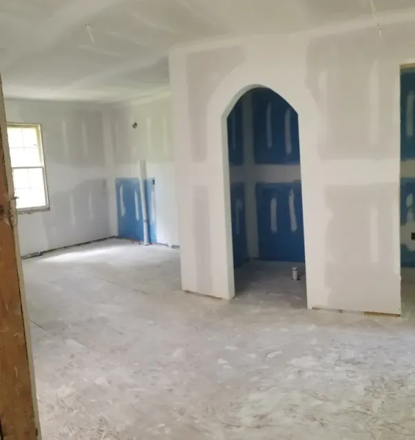 An empty room with white walls and blue doors