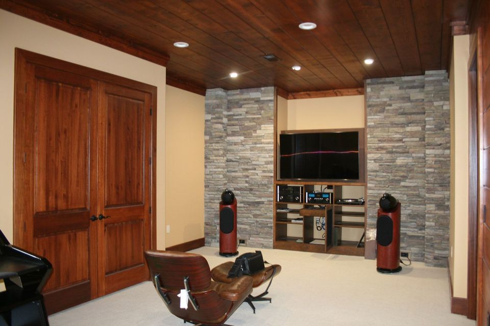 A living room with a chair and a flat screen tv