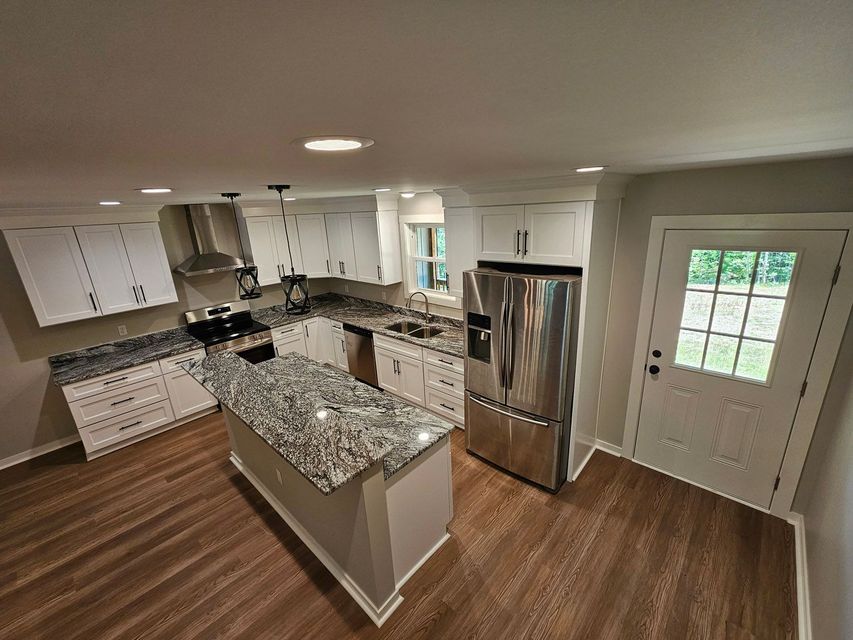 A kitchen with granite counter tops and stainless steel appliances