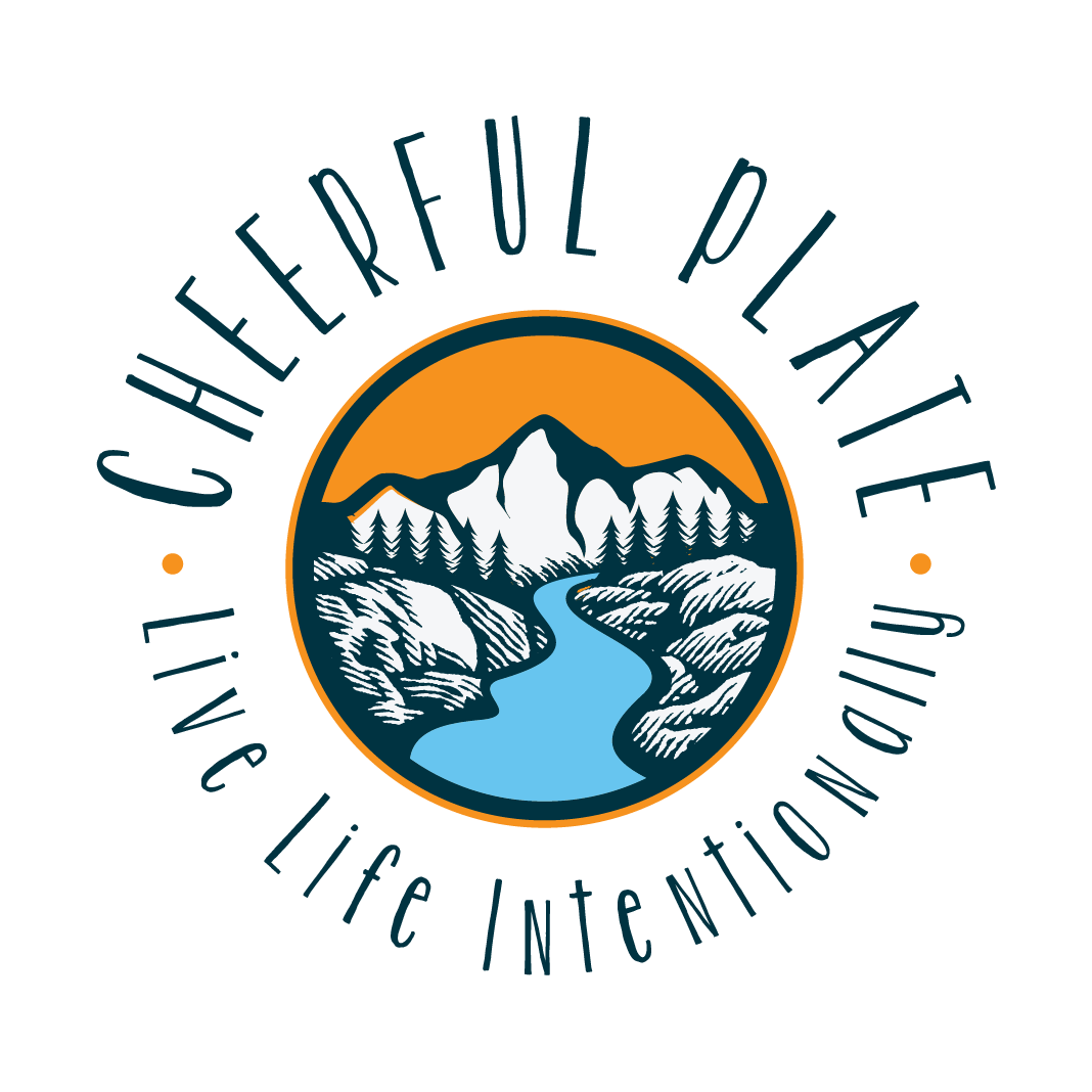 The logo for cheerful plate is a circle with mountains and a river in it.