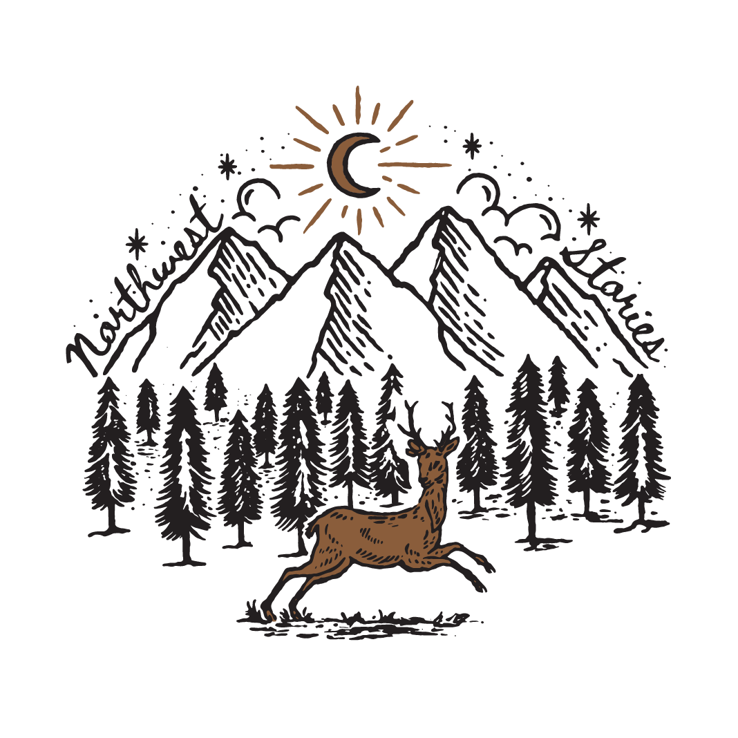 A deer is running through a forest with mountains in the background.